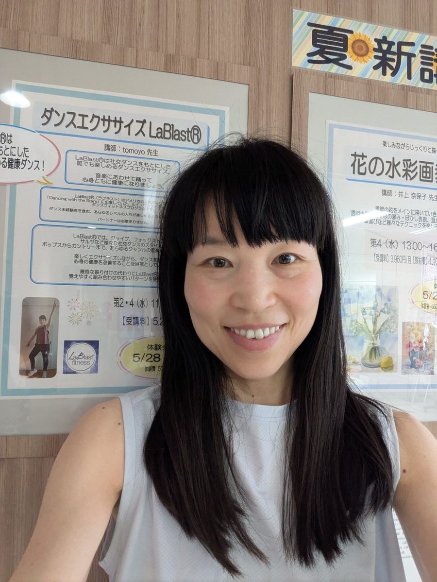 Tomoyo Seo in front of her LaBlast dance exercise class poster